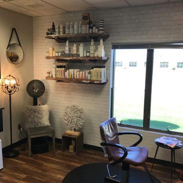 Photo of hair studio including window and comfortable, calm setting.