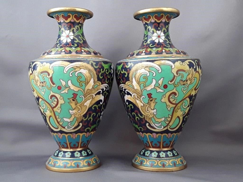 Pair of ornate cloisonné vases with intricate floral and mythical patterns.