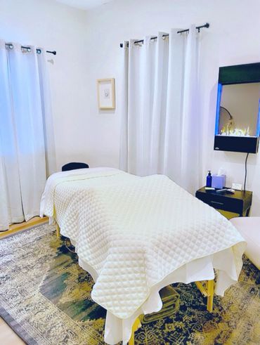 Cozy massage room with soft lighting and neutral decor.