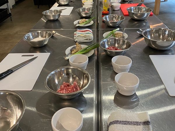 Cooking prep stations with ingredients and utensils.