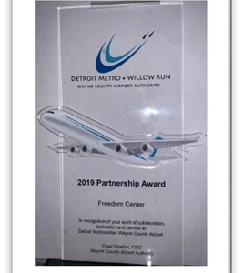 2019 Partnership Award plaque with airplane and Detroit Metro-Willow Run logo.