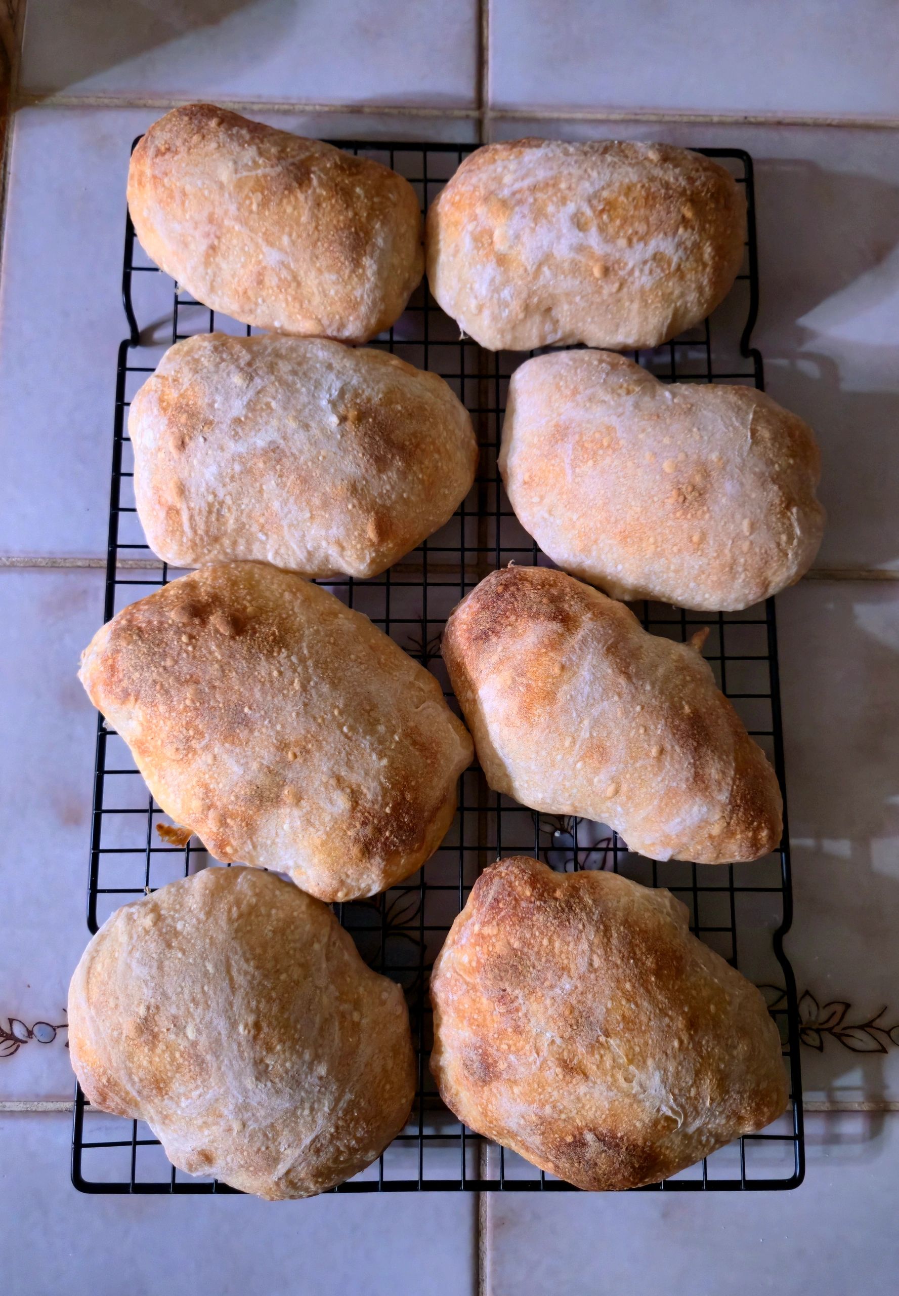 Freshly baked rustic bread cooling on a wire rack.