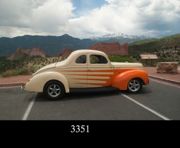 Classic cream and orange vintage car with flame decals.