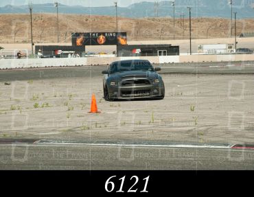 A black sports car on a race track.