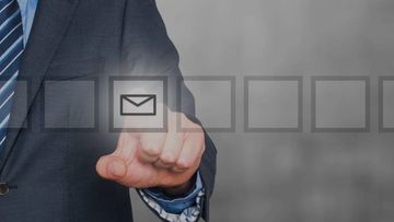 Businessman selecting an email icon on a virtual interface.