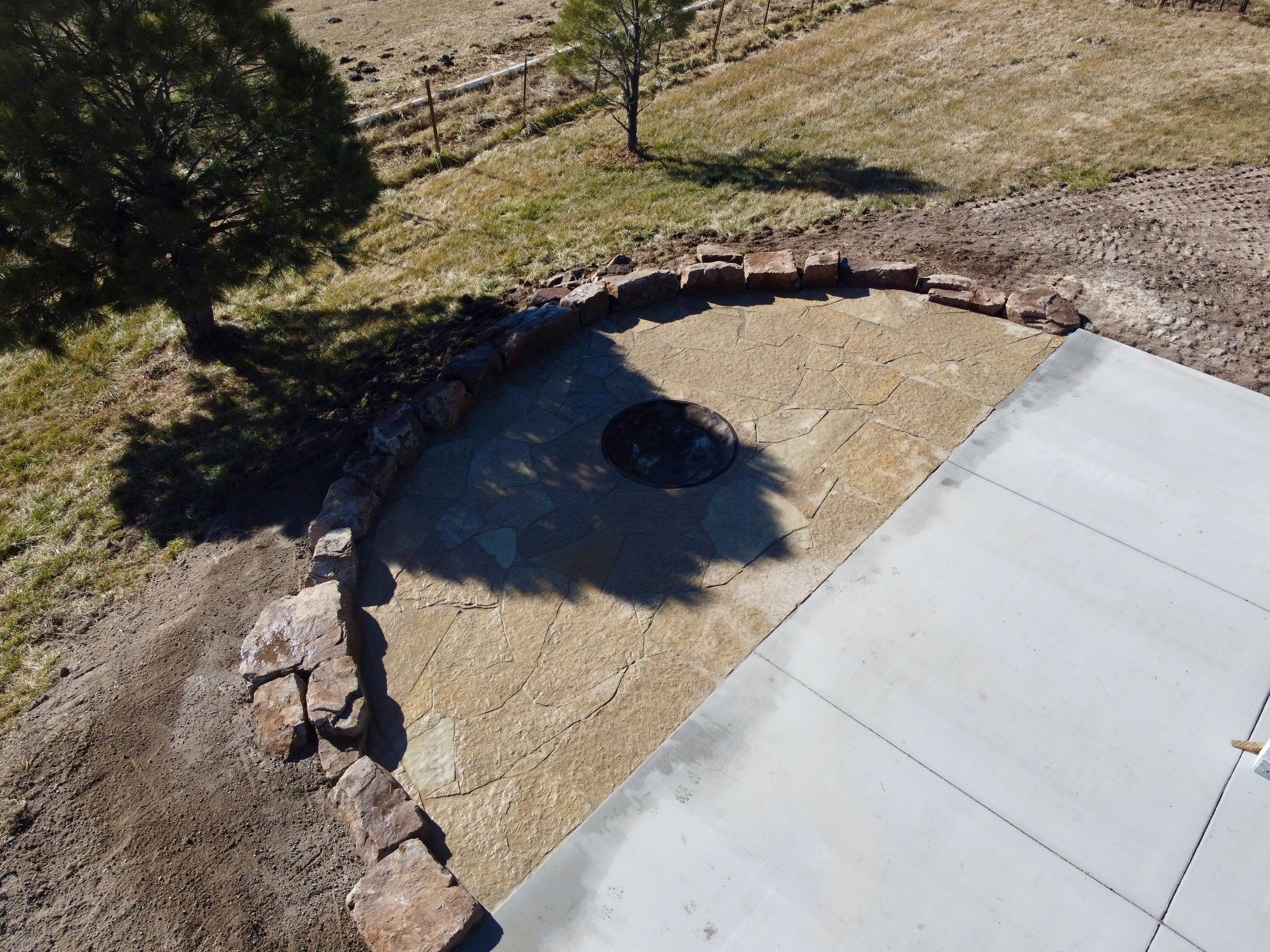 Flagstone Patio, Fire Pit and Moss Rock Install in Farmington, NM By Landscaper in Farmington, NM