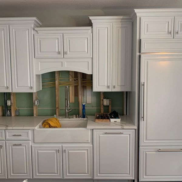 White Kitchen cabinets painted with nickel hardware for doors and draws. Texas supreme painting 