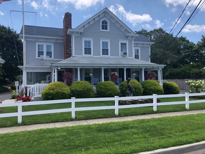 Main house with office on the left. ADA Accessible parking spots.