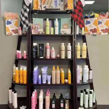 Shelf filled with various hair care products and two decorative stockings.