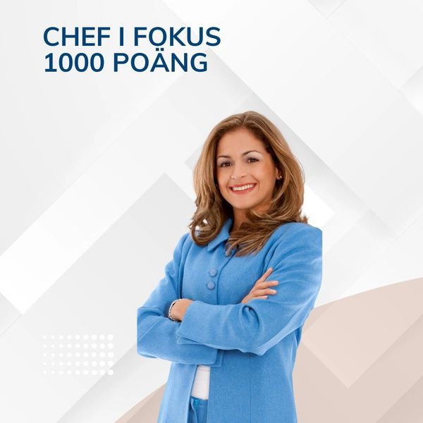 Confident woman in a blue coat smiling with arms crossed.