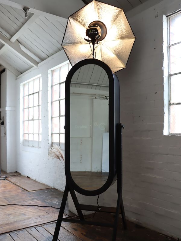 Black Retro Magic Mirror with light on umbrella flash in white industrial room