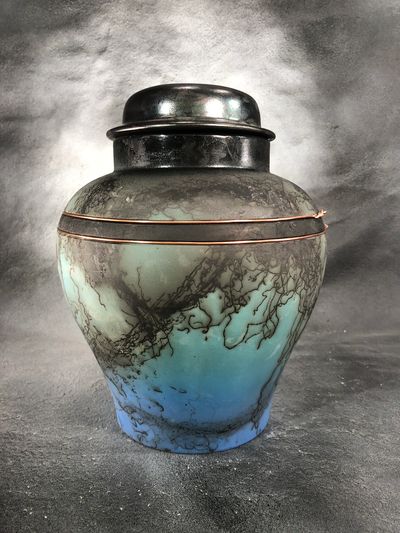 Blue, turquoise and black ceramic horse hair fired urn adorned with copper wire. 