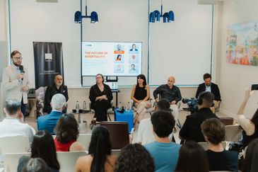 Panel discussion on hospitality with audience present.