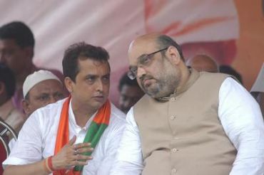 Two men in serious conversation at a public event.