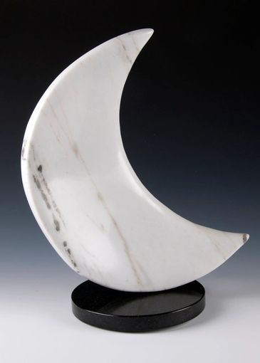 CO Yule Marble sculpture. crescent-shaped. one side is concave the other convex. turntable base