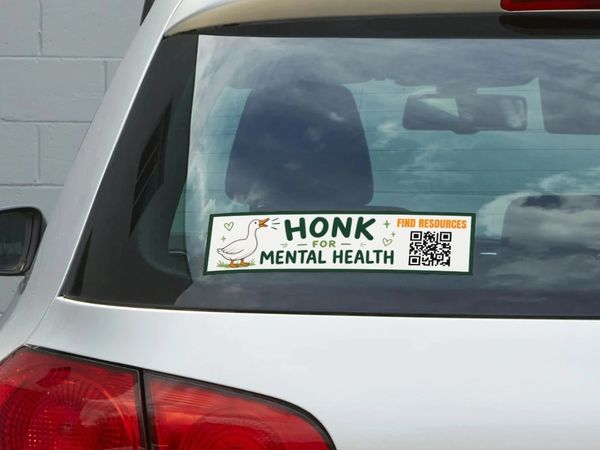 Car sticker saying "Honk for Mental Health" with a QR code for resources.