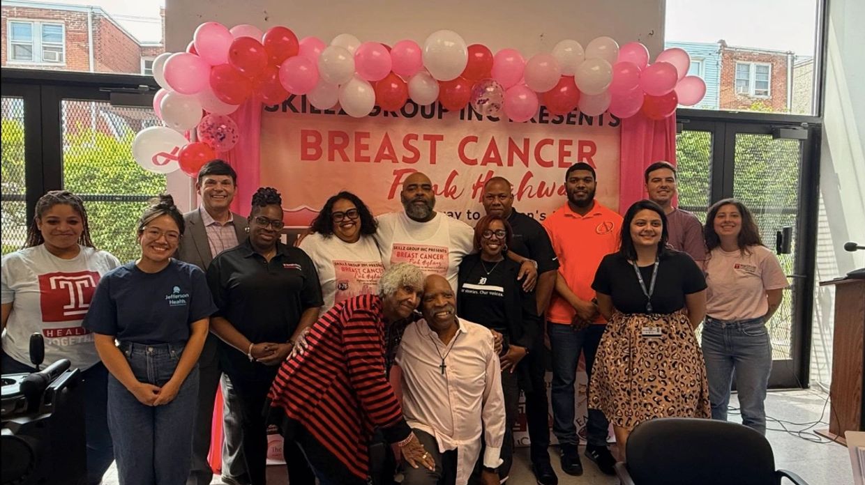 Group photo at a breast cancer awareness event.