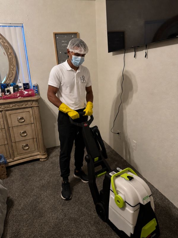 H&R Services technician using professional carpet extraction equipment in Las Vegas