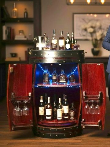 Well-dressed couple enjoying drinks by a stylish liquor cabinet.