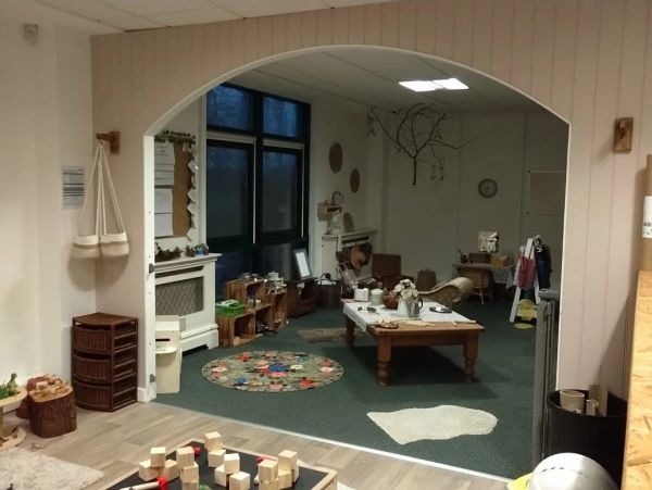 Cozy classroom corner with toys and educational materials.