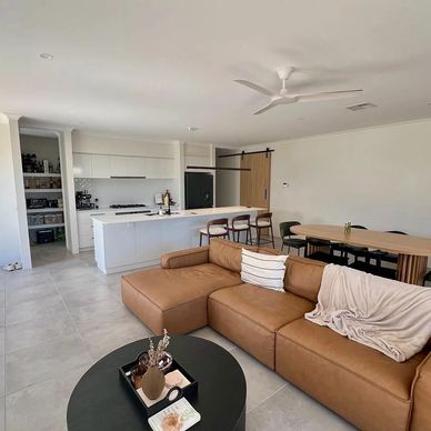 Open plan living and kitchen with island bench in modern Perth home
