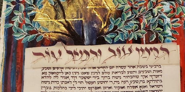 Decorative Hebrew text beneath a vibrant tree mural with colorful leaves.