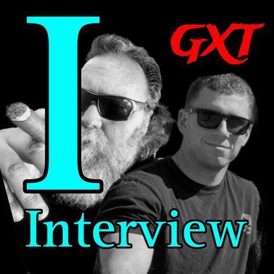 Two men wearing sunglasses with text 'Interview' and 'GXT'.