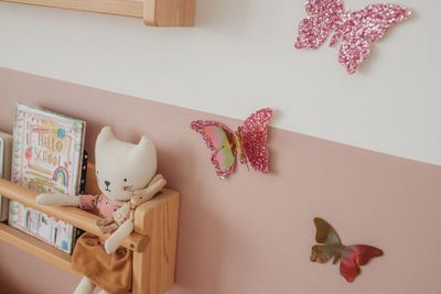 butterfly wall stickers in childrens bedroom next to bookshelf