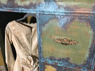 Repurposed vintage wardrobe with an elegant antique wedding gown