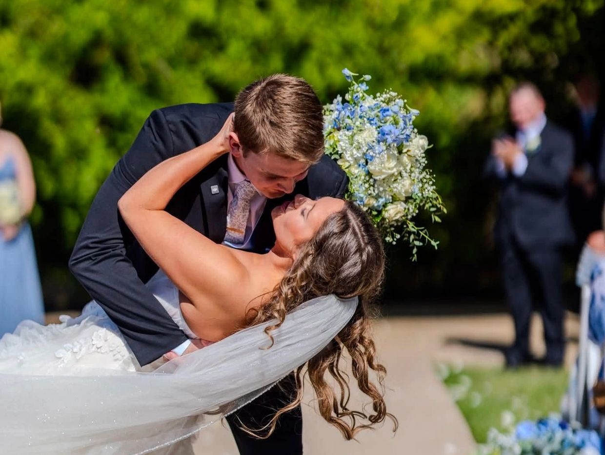 Bride and groom share a kiss during their wedding.