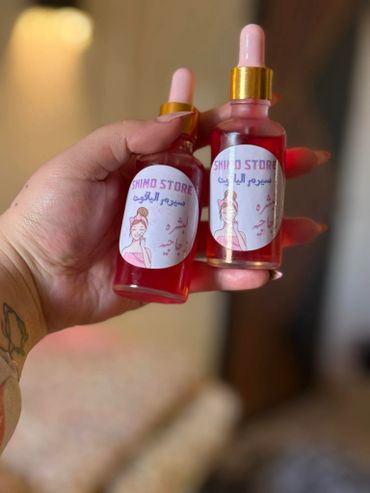 Hand holding two pink dropper bottles labeled SHIMO STORE skin serum.