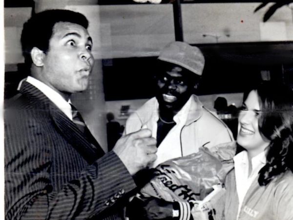 Black and white photo with three people, one surprised, another smiling.