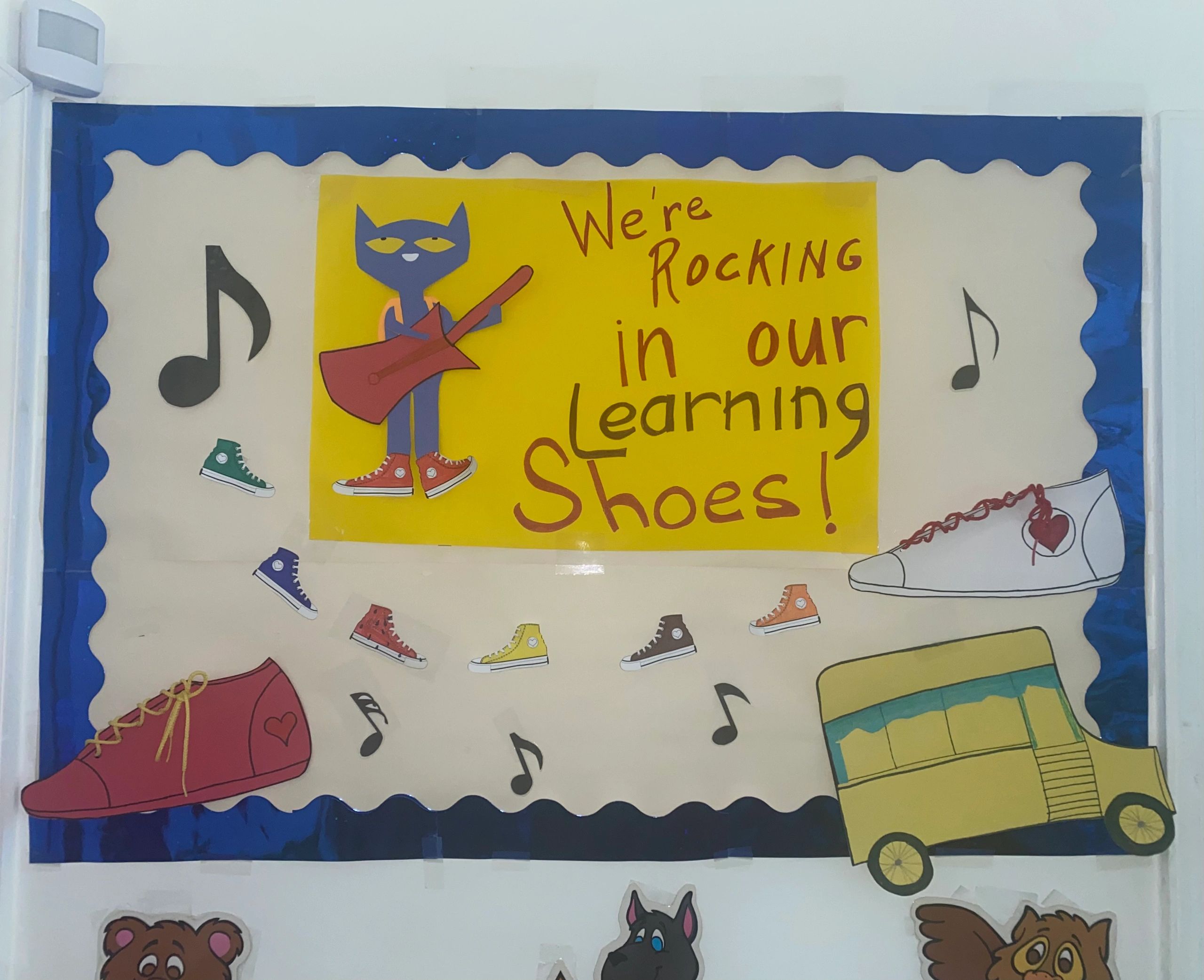 Classroom bulletin board with shoes and music theme.