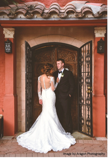 Bride and groom in front of Main House doors. 
