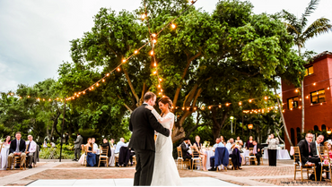 Bride and groom dancing in the outdoor terrace. 