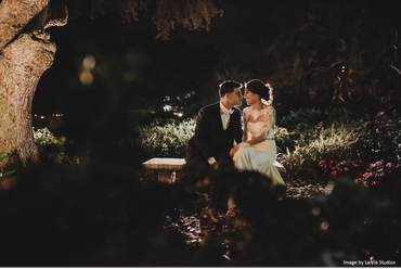 Bride and groom under the tree at the pond area. 