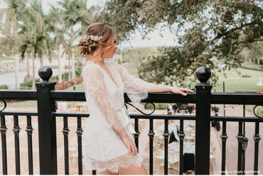 Bride looking over bridal suite balcony. 