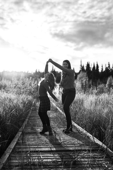 Two sisters dancing in the sun at Baywood Park in Cold Lake Alberta.