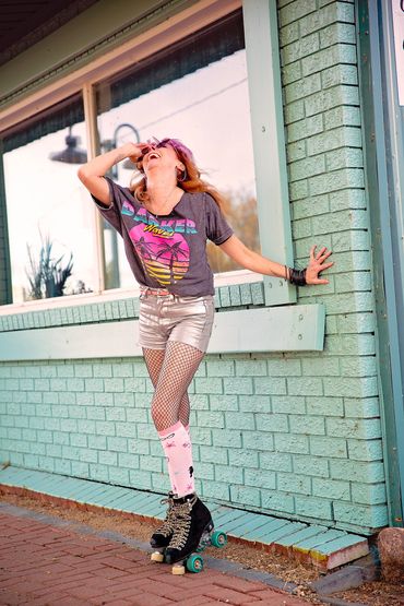 Roller Haus owner in Cold Lake Alberta portrait session at the Marina wearing roller skates.