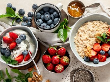 Healthy breakfast with berries, oatmeal, and nuts.