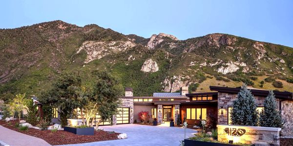 Modern house at mountain base during twilight.