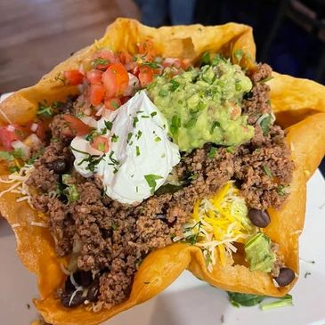 Taco salad with seasoned beef, guacamole, sour cream, and pico de gallo in a crispy shell.