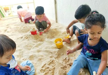 Children playing in the sand pit at Hummingbird Preschool