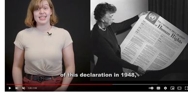 A woman presents the 1948 Universal Declaration of Human Rights.