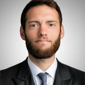 Professional man with beard in suit and tie.