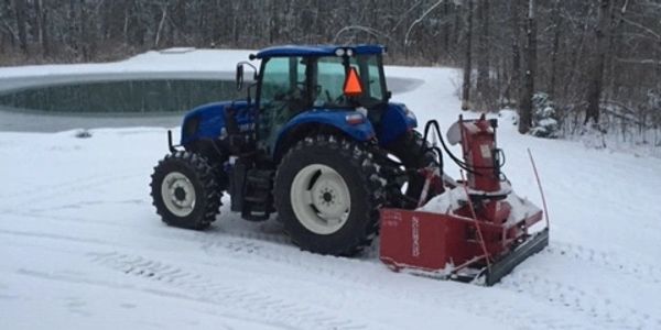 Snow blower and New Holland tractor