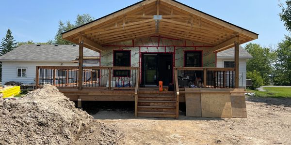 Rear Home Addition; large open concept living room, wrap around deck, two basement bedrooms
