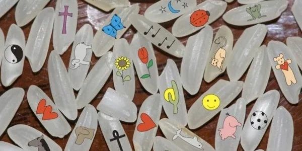 Rice grains decorated with various colorful small drawings.