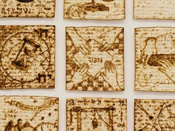 Framed artwork with nine ancient map-like tiles.