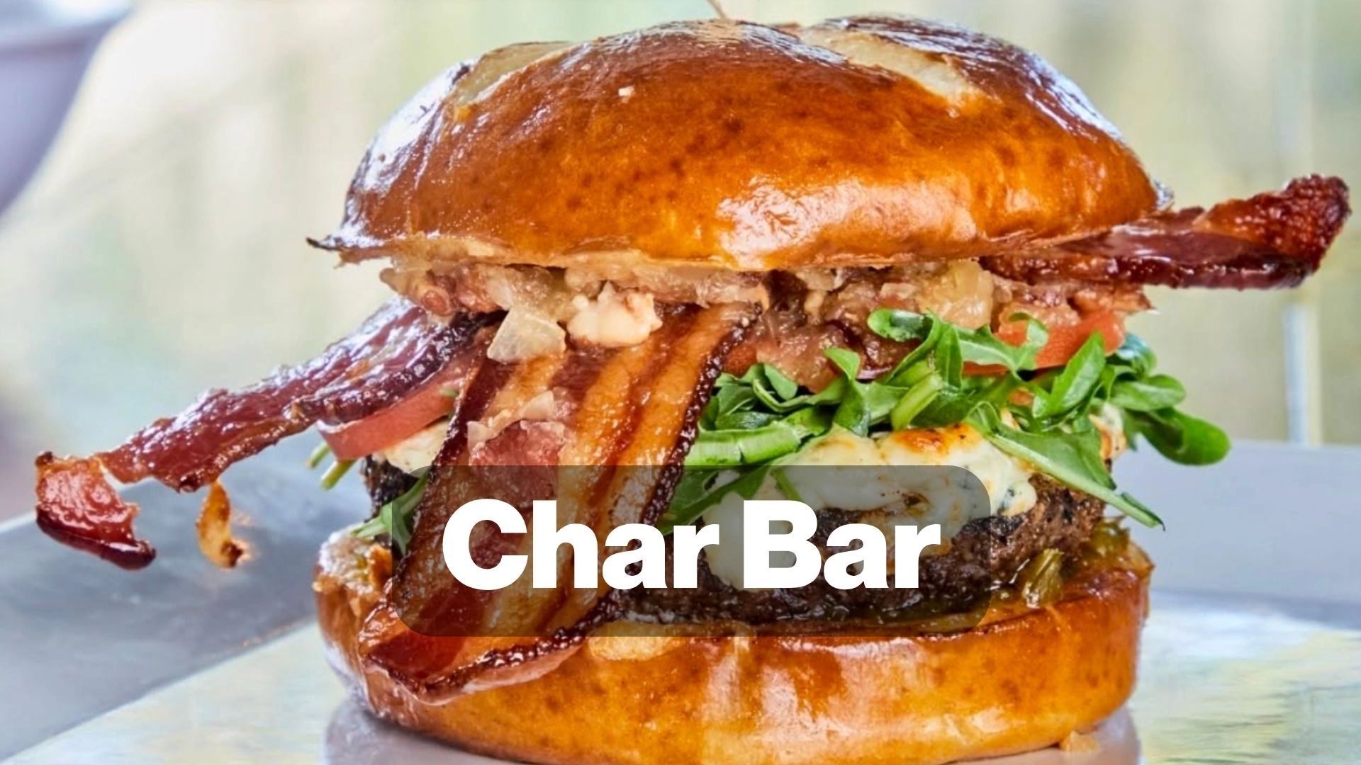 Close-up of a loaded bacon burger from Char Bar.
